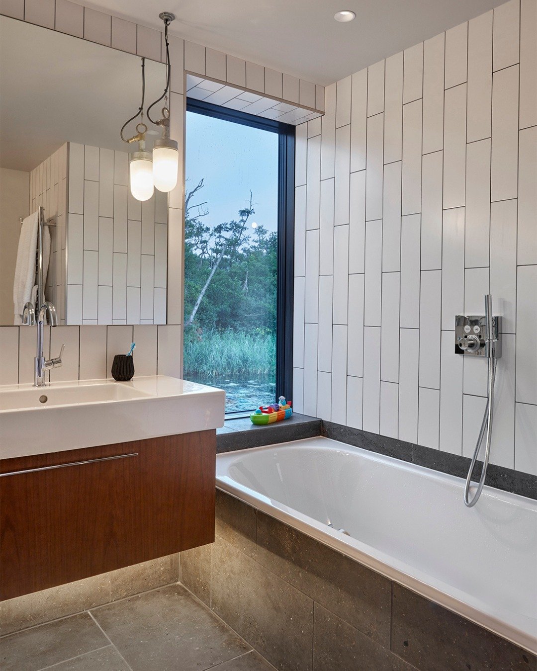 Would you want to sink into a bath here?

At @backwater_norfolk on the Norfolk Broads, a large window sits right at the end of the tub, framing the reeds and water beyond. A tranquil view out into the Broads, and the sense of bathing almost in the la
