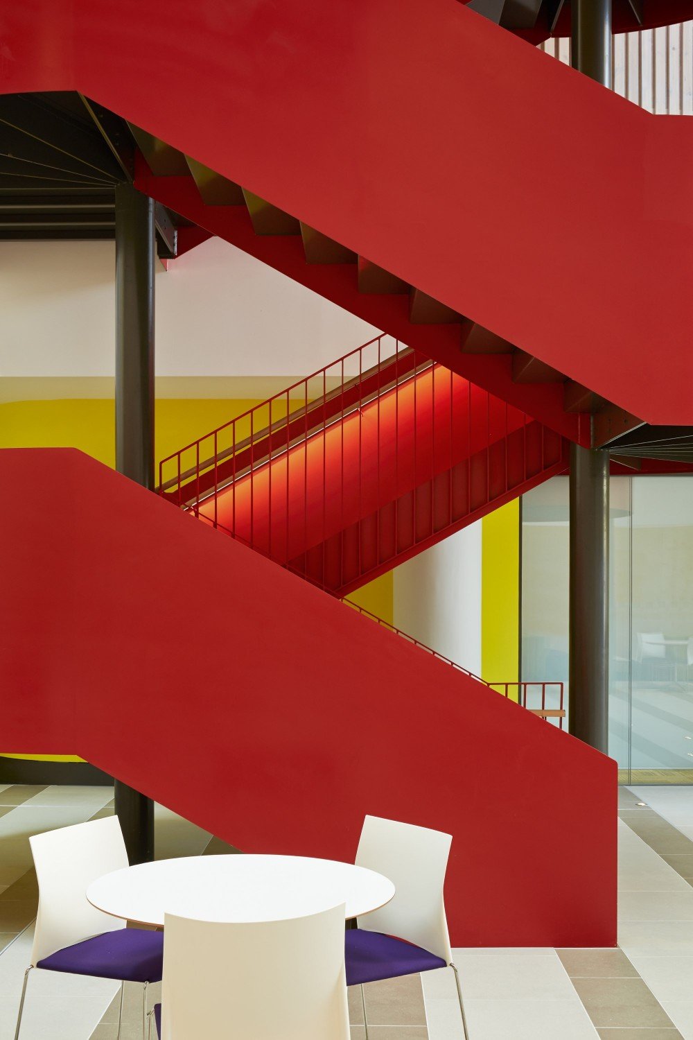 Striking red staircase at Southwark College