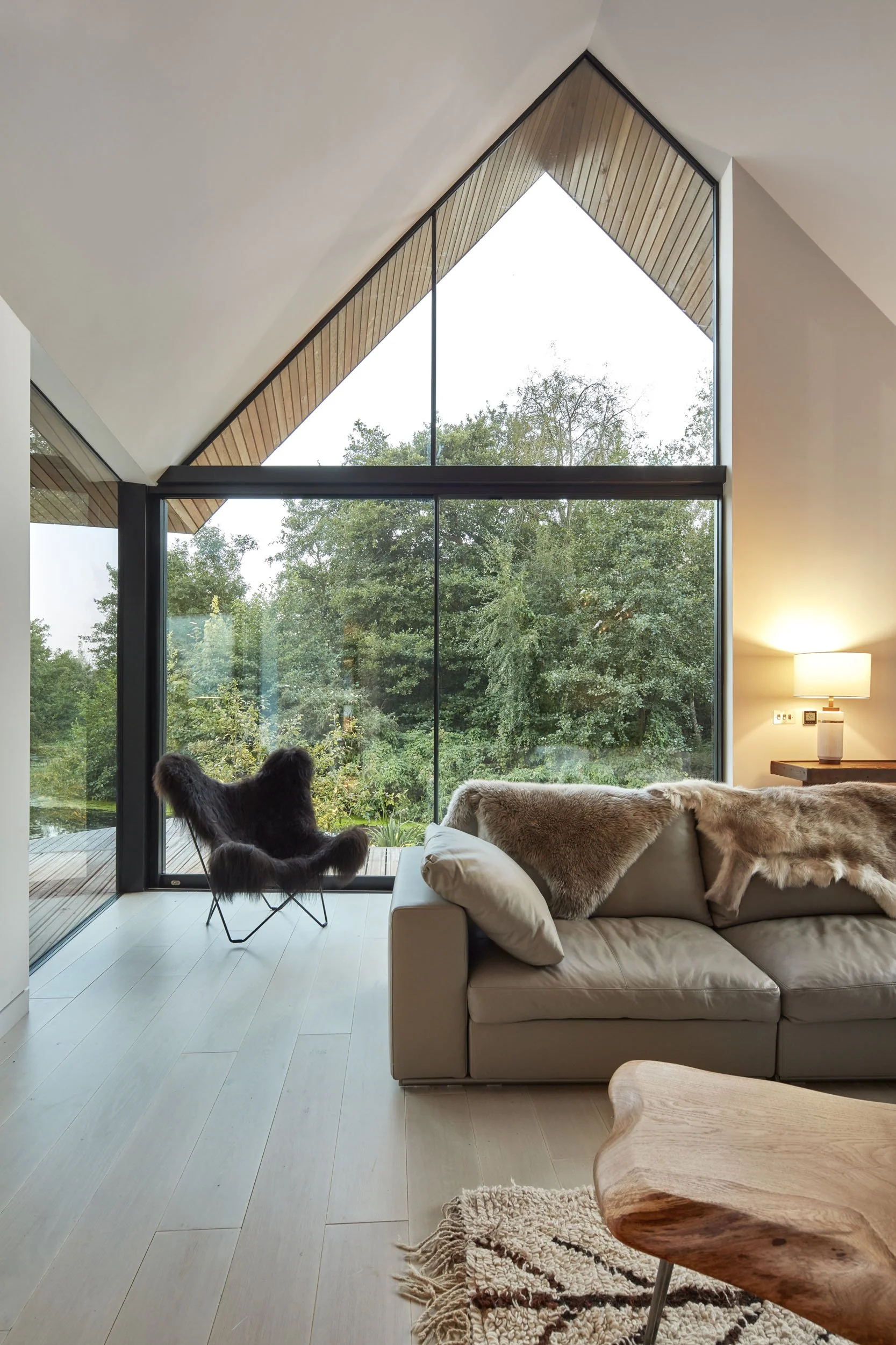 Living space at Backwater with double-height glass