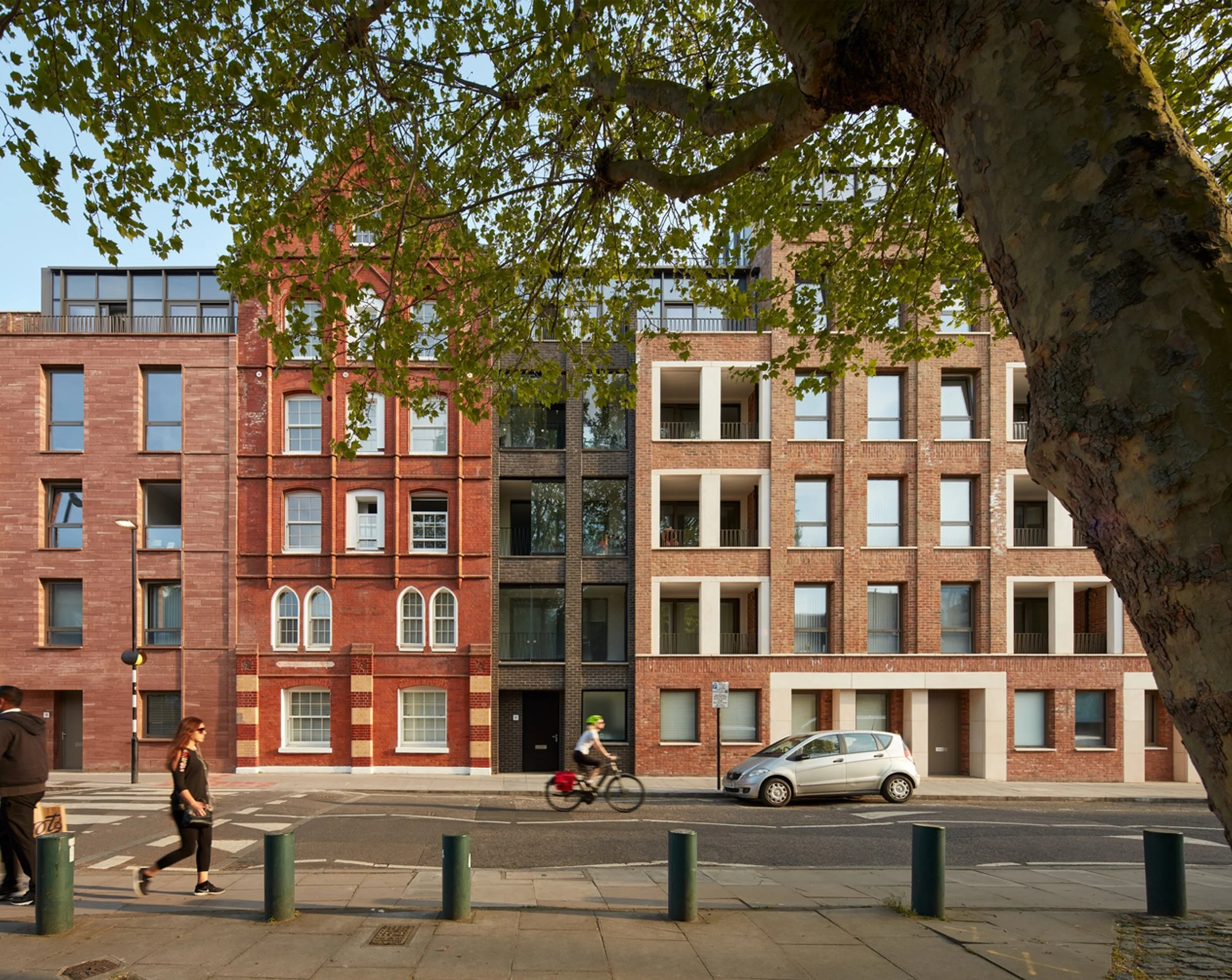 Street view of Toynbee Hall with cyclist and walker