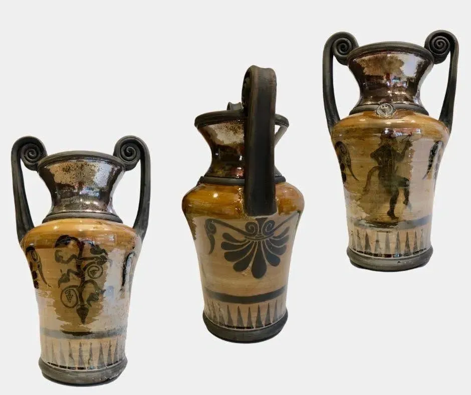 Three ancient Greek-style ceramic vases with black handles and decorative patterns, displayed against a plain background.