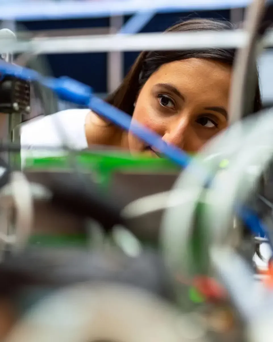 Female engineer inspecting electrical wiring during a technical project