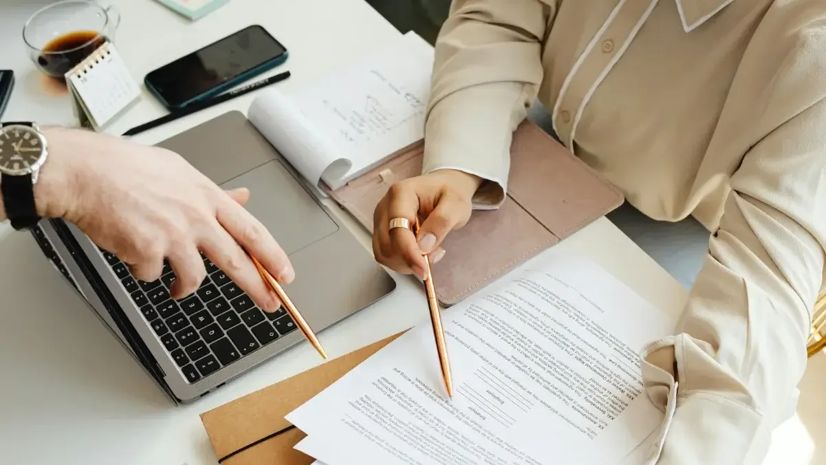 Close up of people reviewing documents