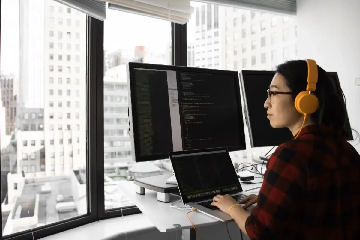 Person sitting at a workstation in an office looking out the window