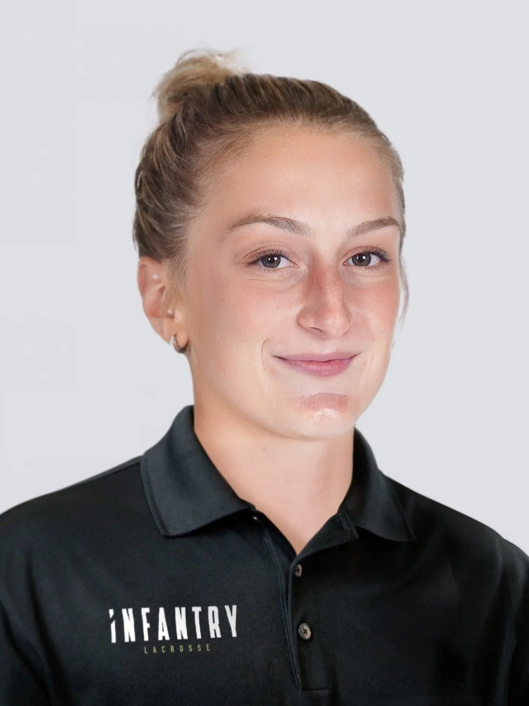 Person wearing a black polo shirt with "Infantry Lacrosse" logo.