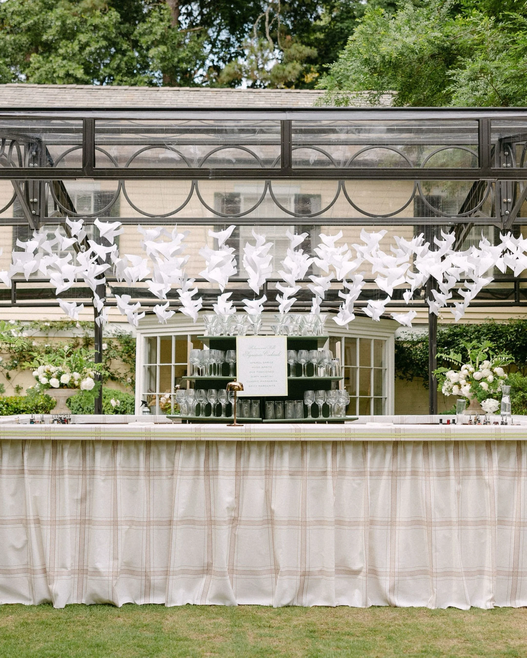 An emotional ceremony and an unforgettable cocktail hour for the Kesterton wedding. The cocktail hour was centered around the family pool and pool house, with a custom glass atrium framing the main lawn to welcome guests with signature drinks and a s