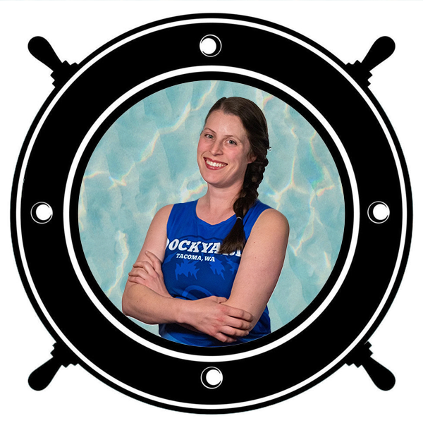 A woman wearing a black helmet and sports gear, including a blue sleeveless jersey, seen through a circular porthole. 
