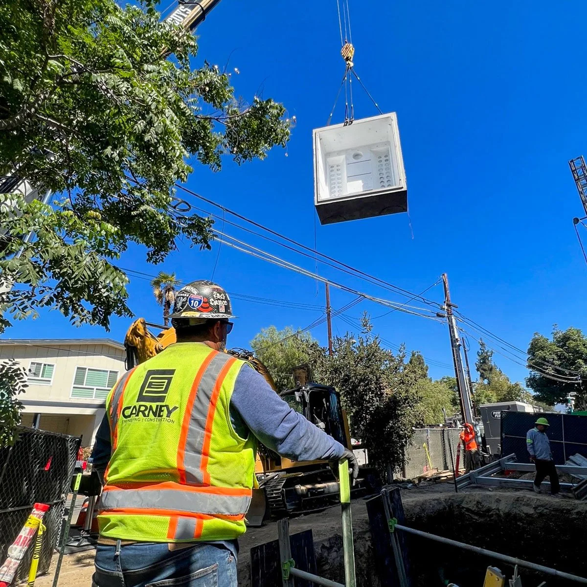 carney engineering construction installing underground water reservoir using crane
