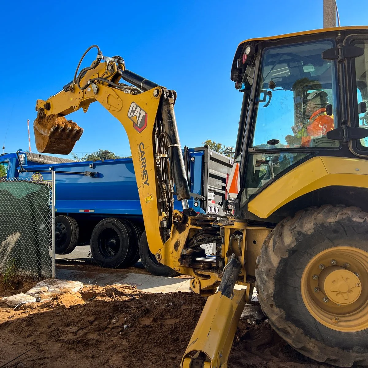carney engineering construction digging trench with backhoe
