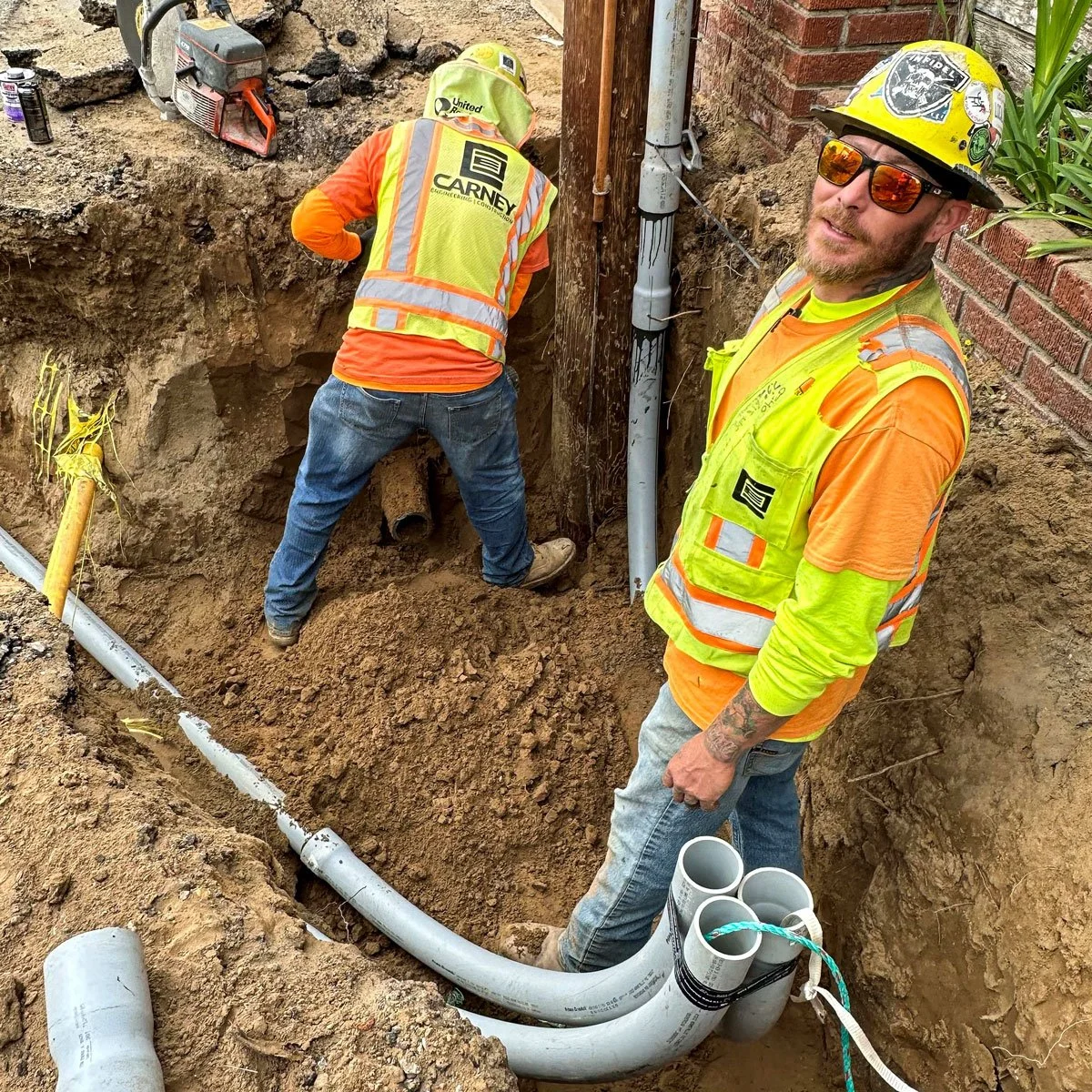 carney engineering construction employees installing underground utilities