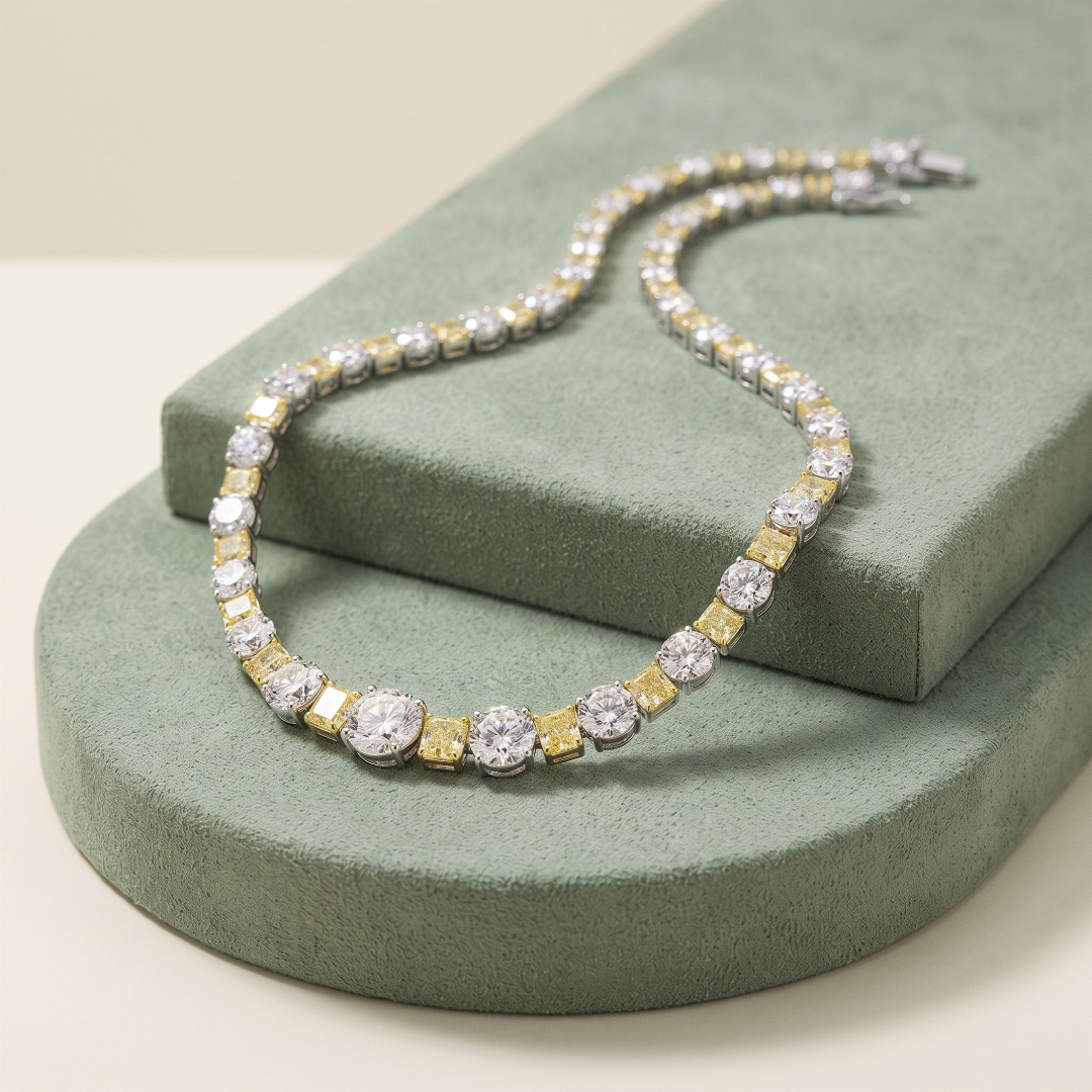 A diamond and gold necklace displayed on green textured jewelry stands.