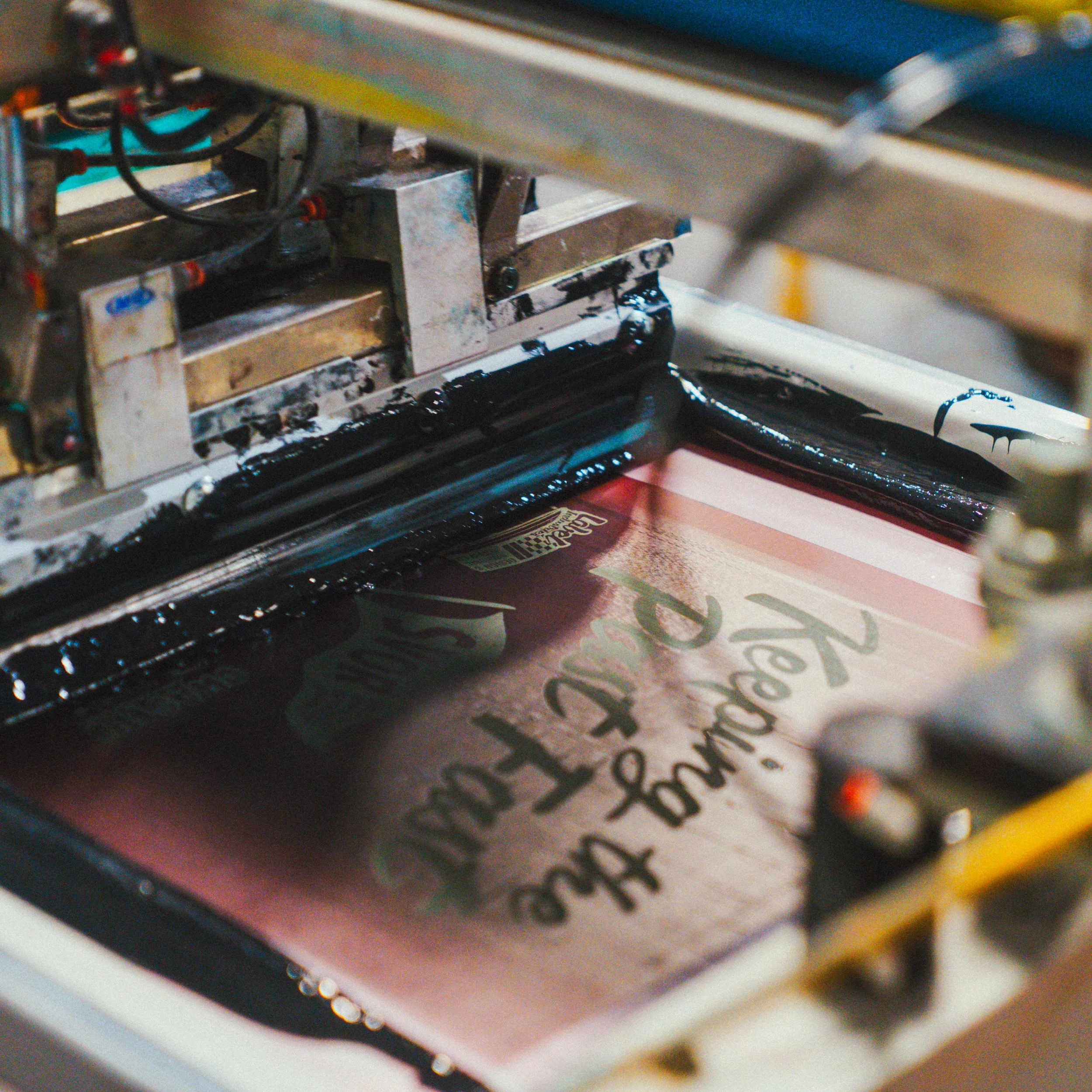 A printing press printing a poster that says 'The Freedom for Truth' with decorative fonts.