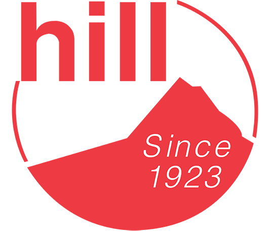 Red circular logo with the words 'hill' at the top, a mountain graphic, and 'Since 1923' at the bottom.