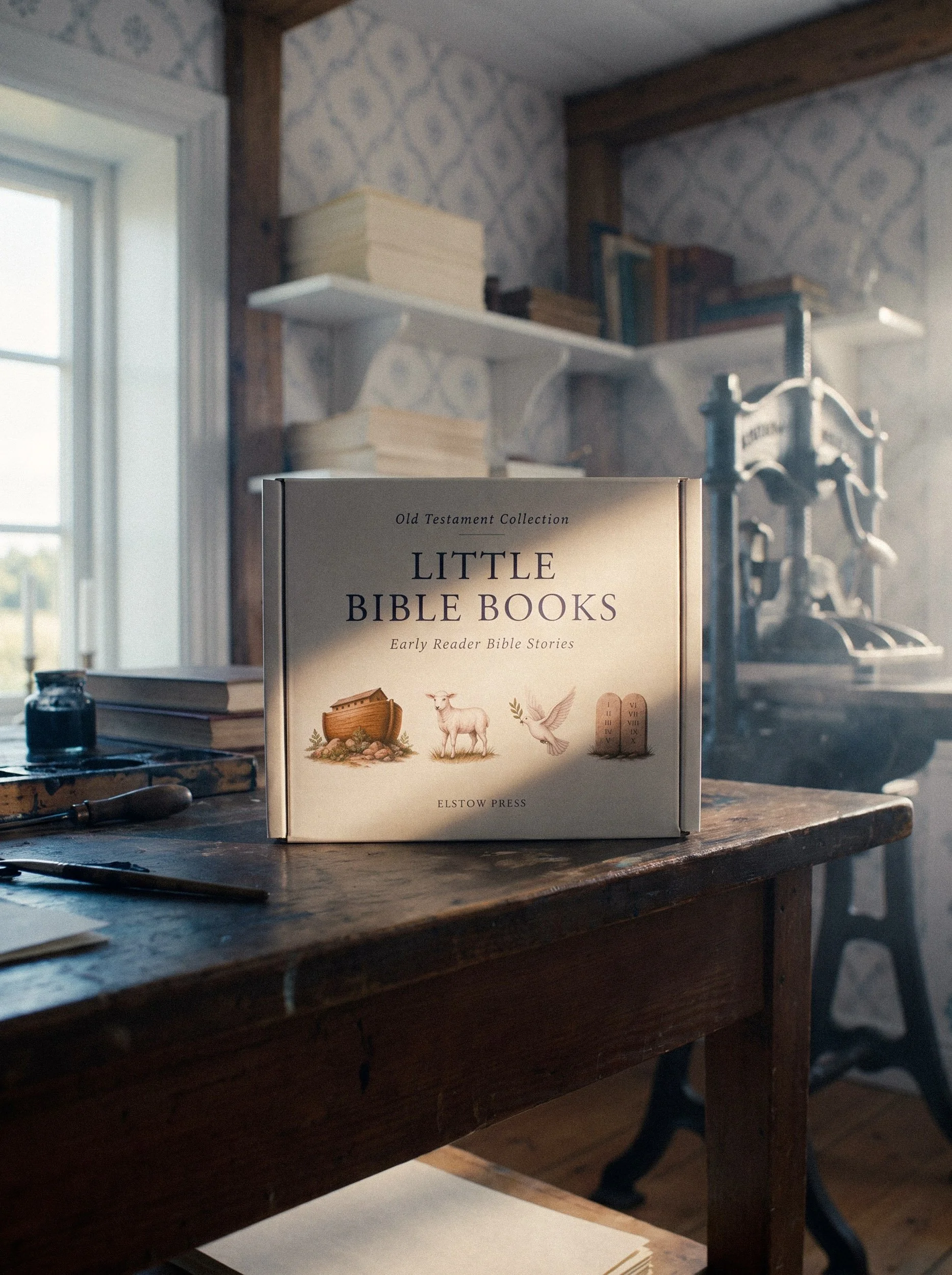 A book titled 'Little Bible Books' from the Old Testament Collection on a wooden table, with a window to the left and shelves of books and metal tools in the background.