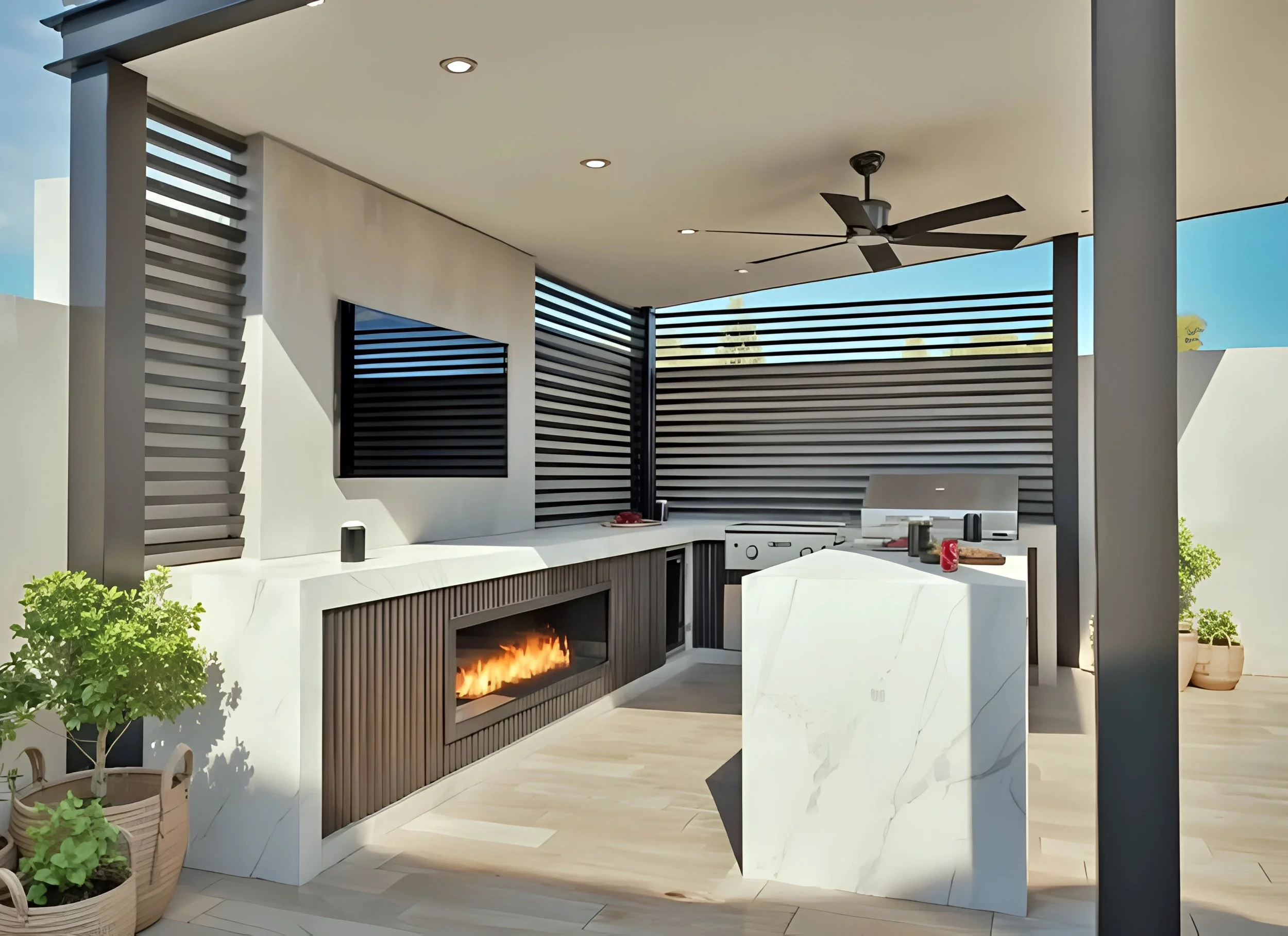 Modern outdoor kitchen with a white marble counter, built-in fireplace, a flat-screen TV, and a ceiling fan with a black blades. Potted plants and a blue sky are visible.