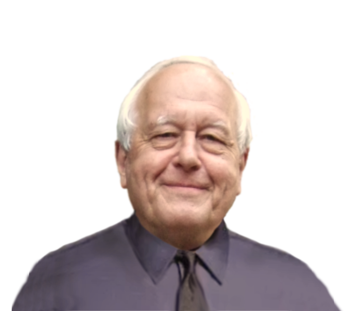 A smiling elderly man with white hair, wearing a dark gray collared shirt.