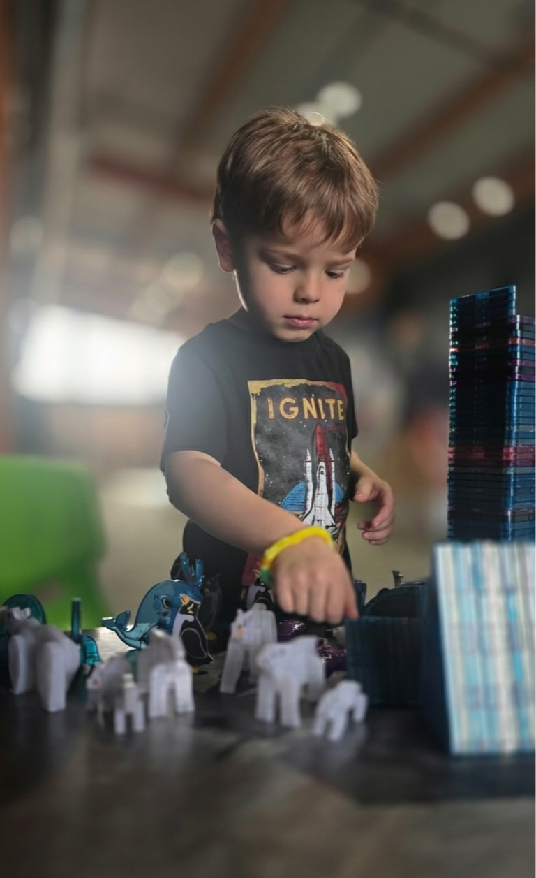 Child learning through play with magnetic tiles at ExplorationWorks in Helena