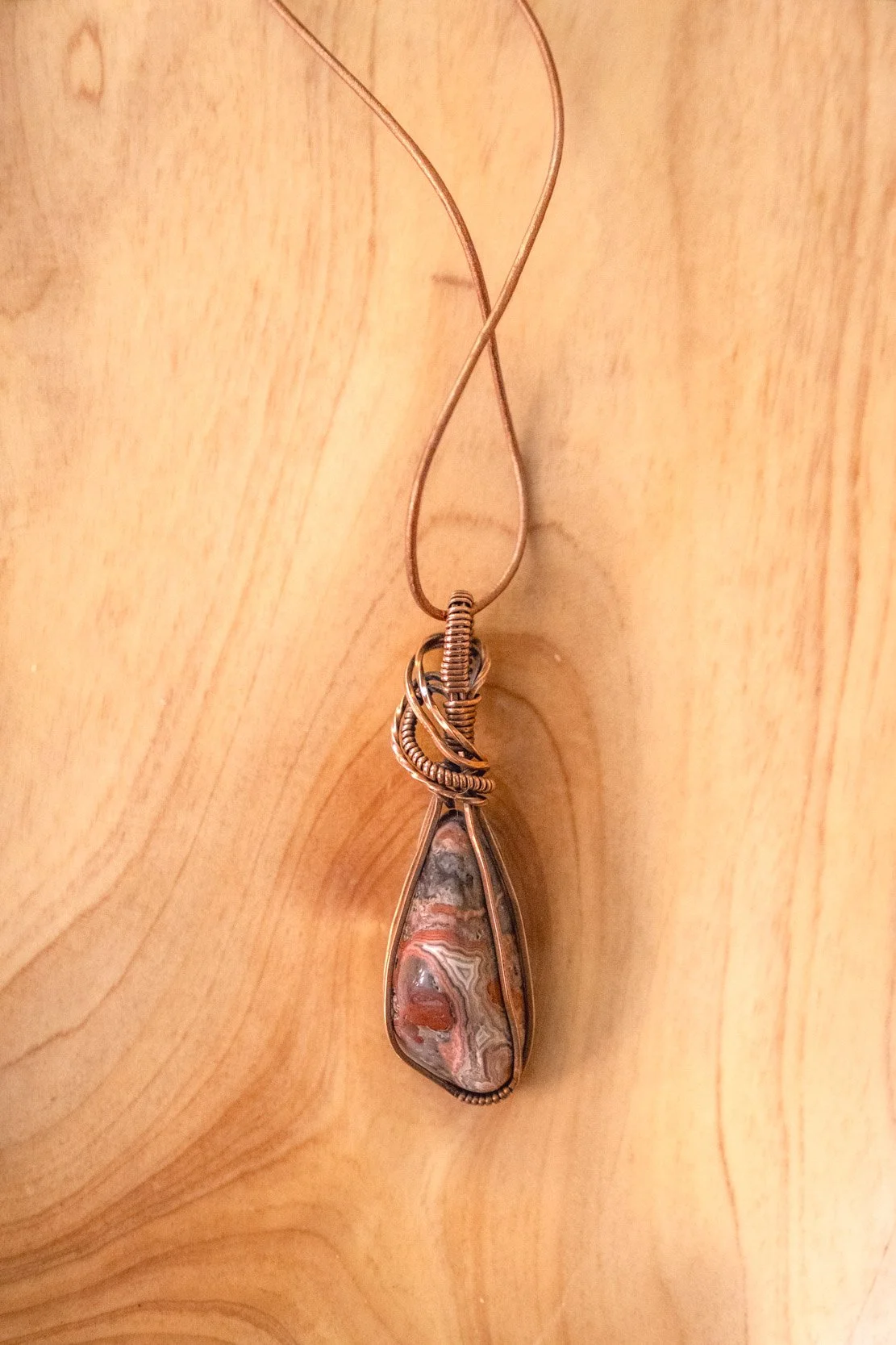 Crazy Lace Agate wrapped in raw copper & oxidized
