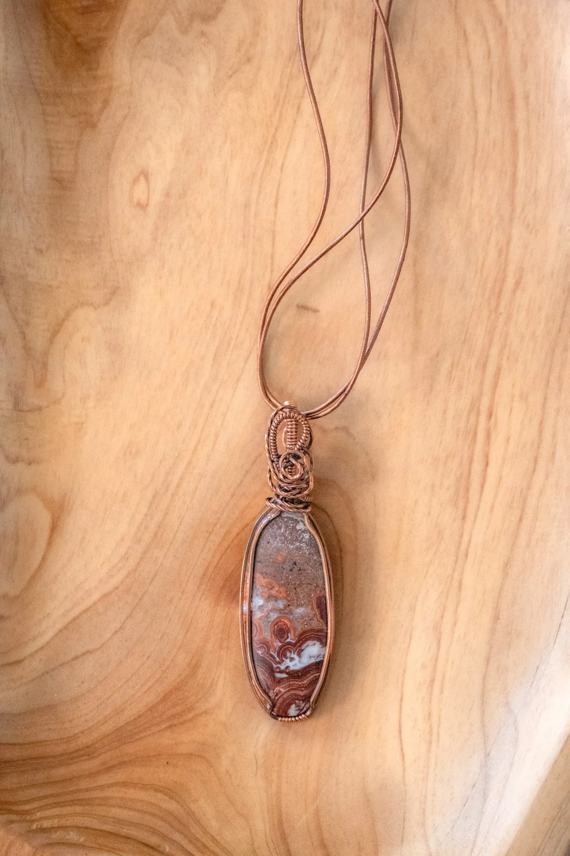 Crazy Lace Agate wrapped in raw copper & oxidized