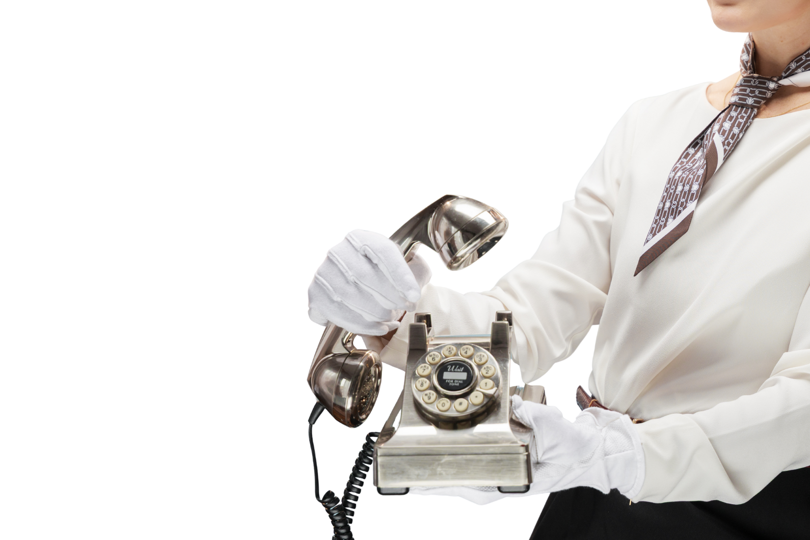 Person dressed in vintage clothing holding a retro rotary phone and a telephone receiver.