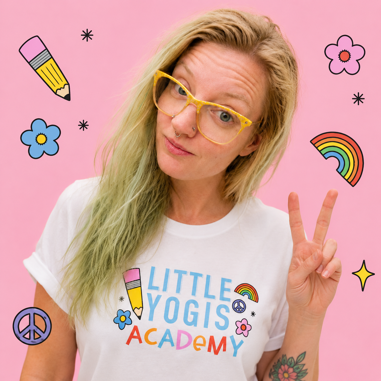 A woman with blonde hair and yellow glasses making a peace sign, wearing a white T-shirt with colorful text and illustrations, against a pink background with floating cartoon doodles of a pencil, flowers, rainbow, peace sign, star, and black asterisks.