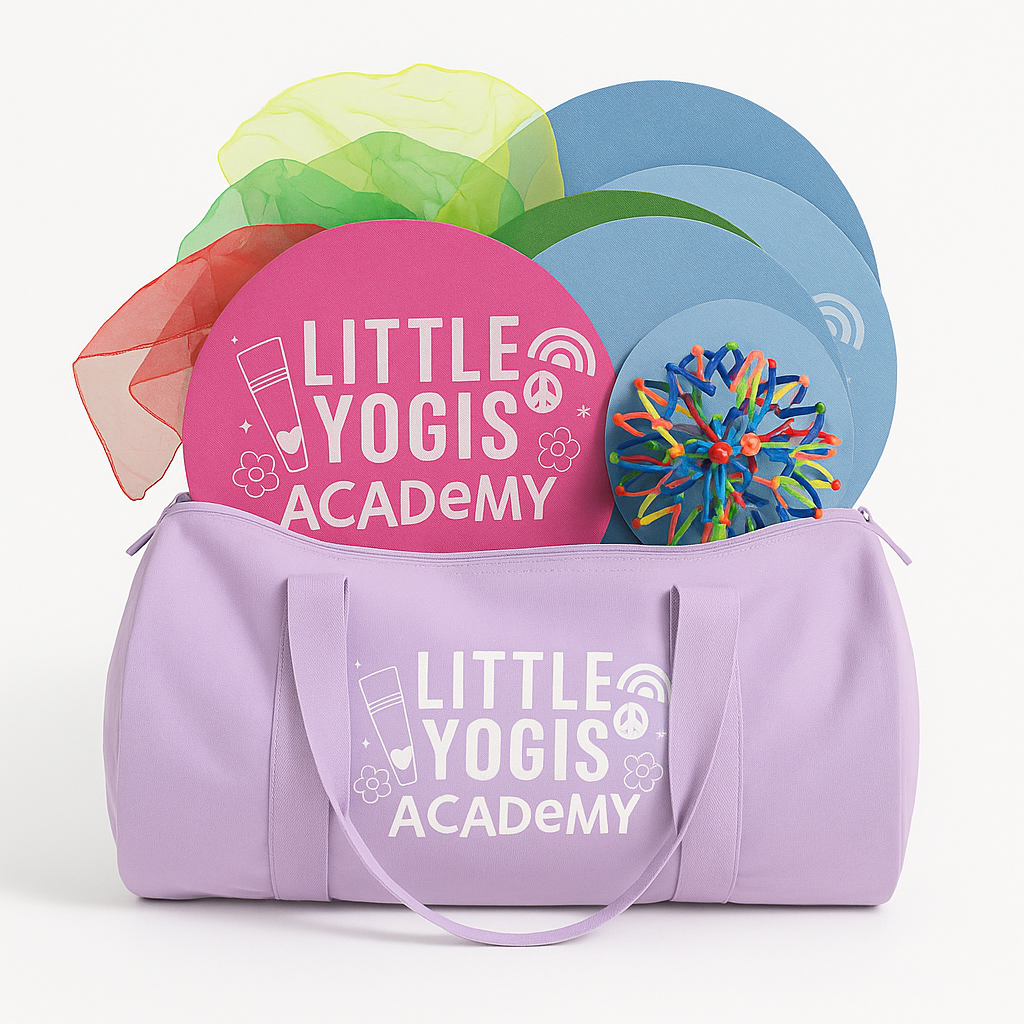 A lavender yoga bag with the logo 'Little Yogis Academy' printed on it, filled with colorful yoga props including round mats, silk scarves, a colorful rubber band ball, and other yoga accessories.