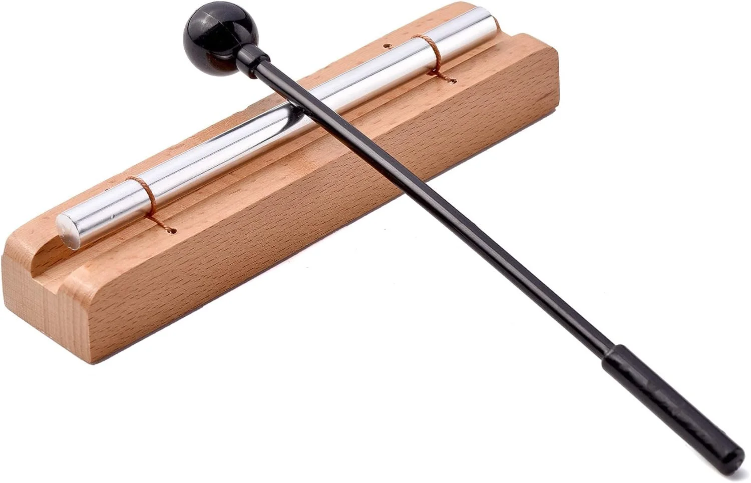 A metal tuning fork mounted on a wooden base with rubber bands, and a black mallet lying diagonally across it.