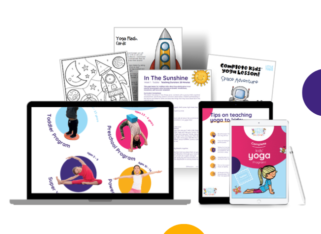 Children's yoga program materials including printed guides, a laptop, a tablet with stylus, and a rocket figurine, all related to kids' yoga education.