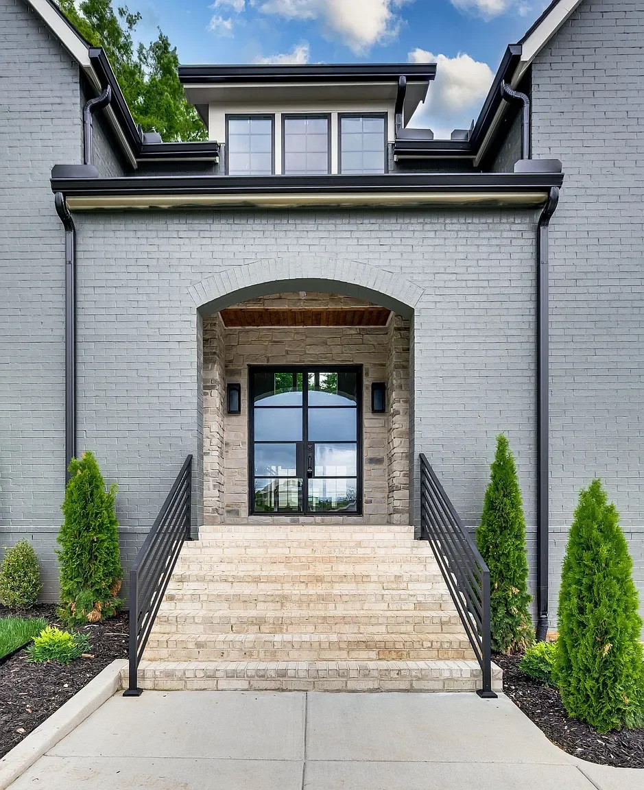 Brick stair entrance with custom handrails