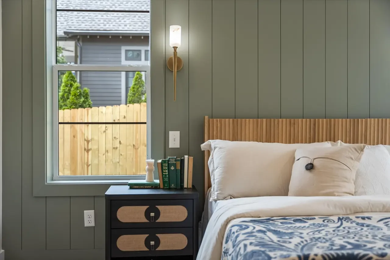 shiplap primary bedroom with sconces for reading lights
