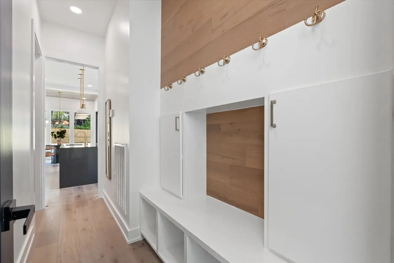 Mudroom custom carpentry built in with hooks and cabinets
