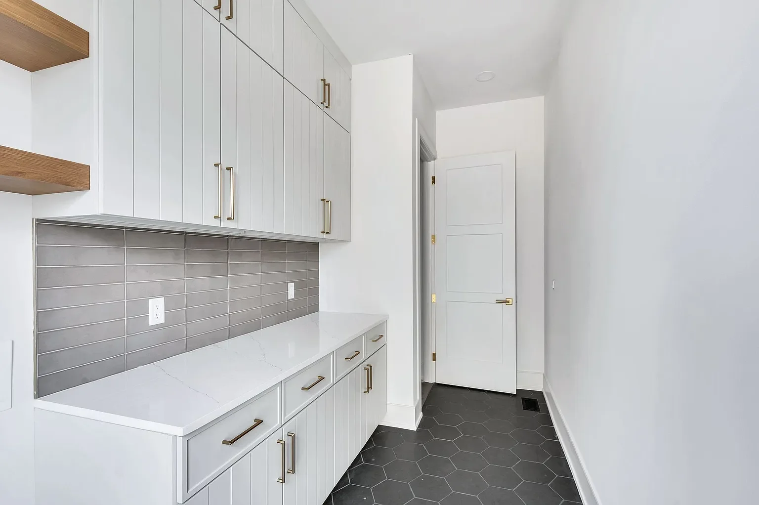 laundry with custom white cabinets