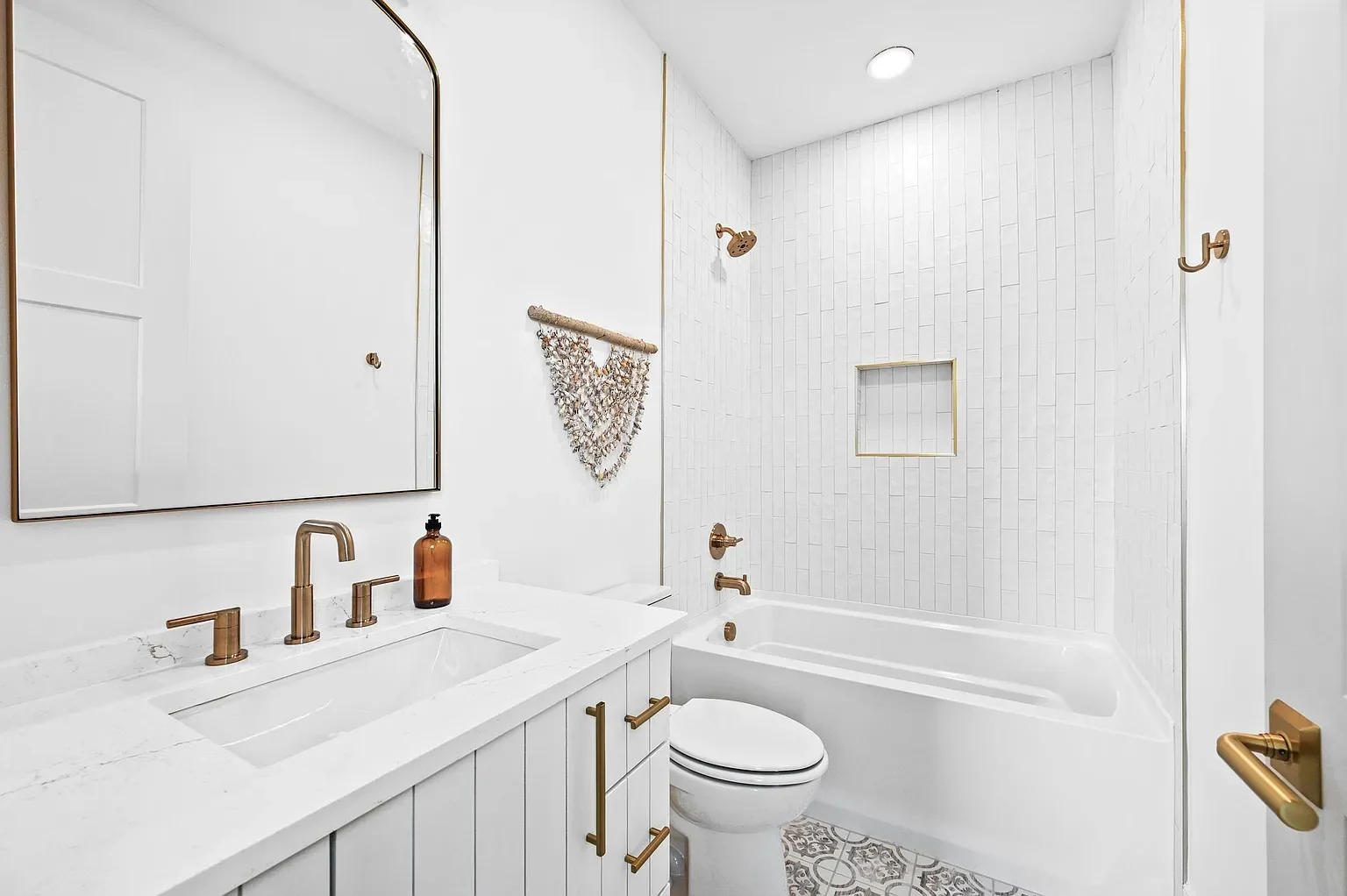 custom white tile with champagne bronze hardware