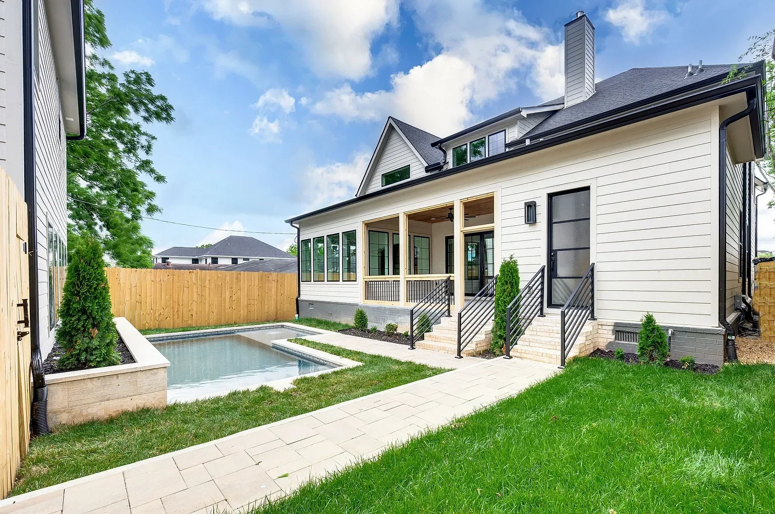 Backyard with pool installed and back porch screen installed