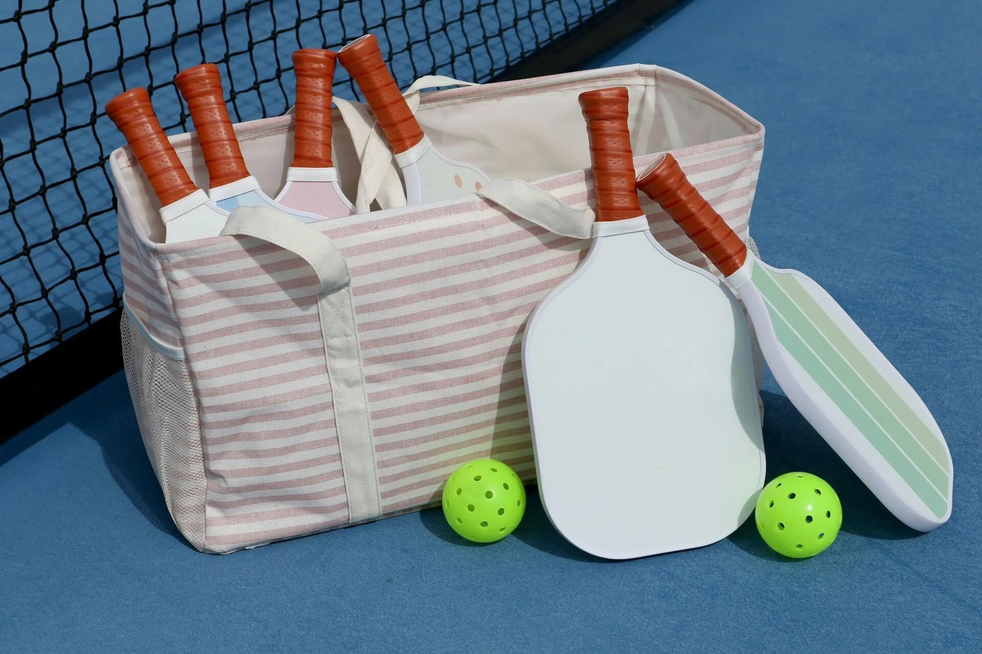 bag of pickleball paddles by the net at baseline gvl