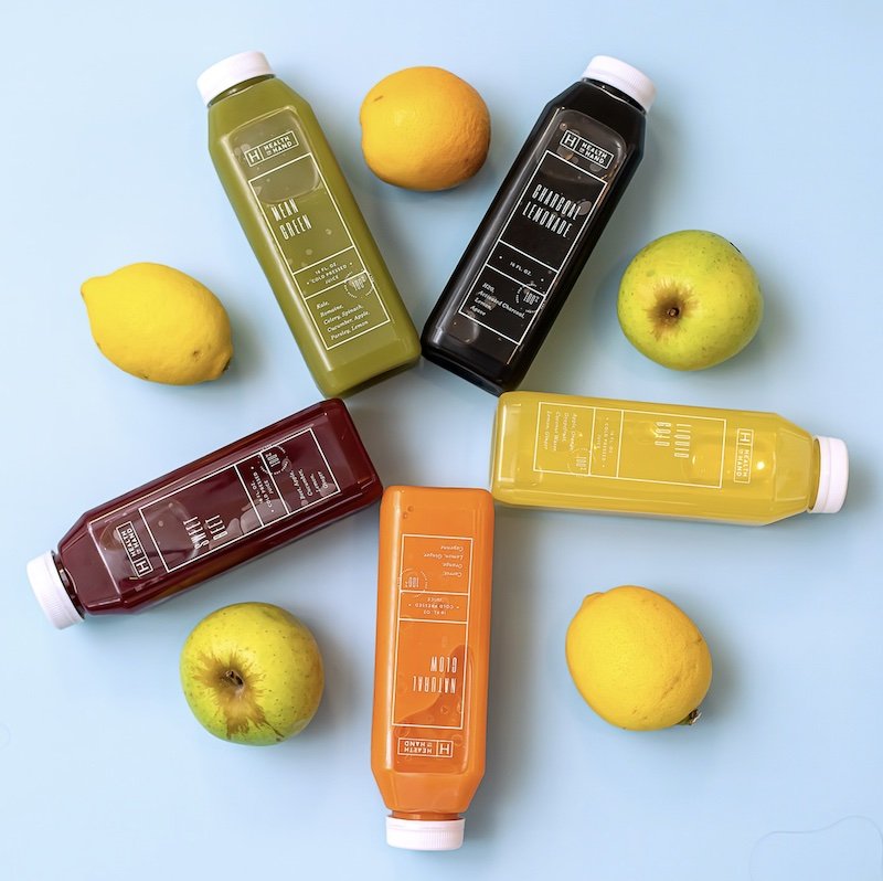 health in hand juice selection arranged with fruit