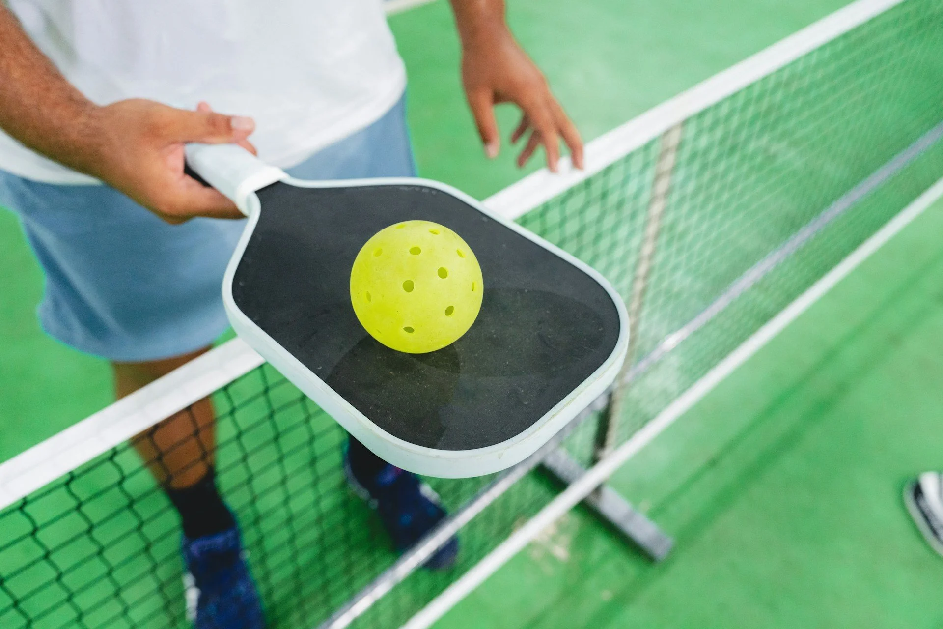 pickleball player at the net in greenville
