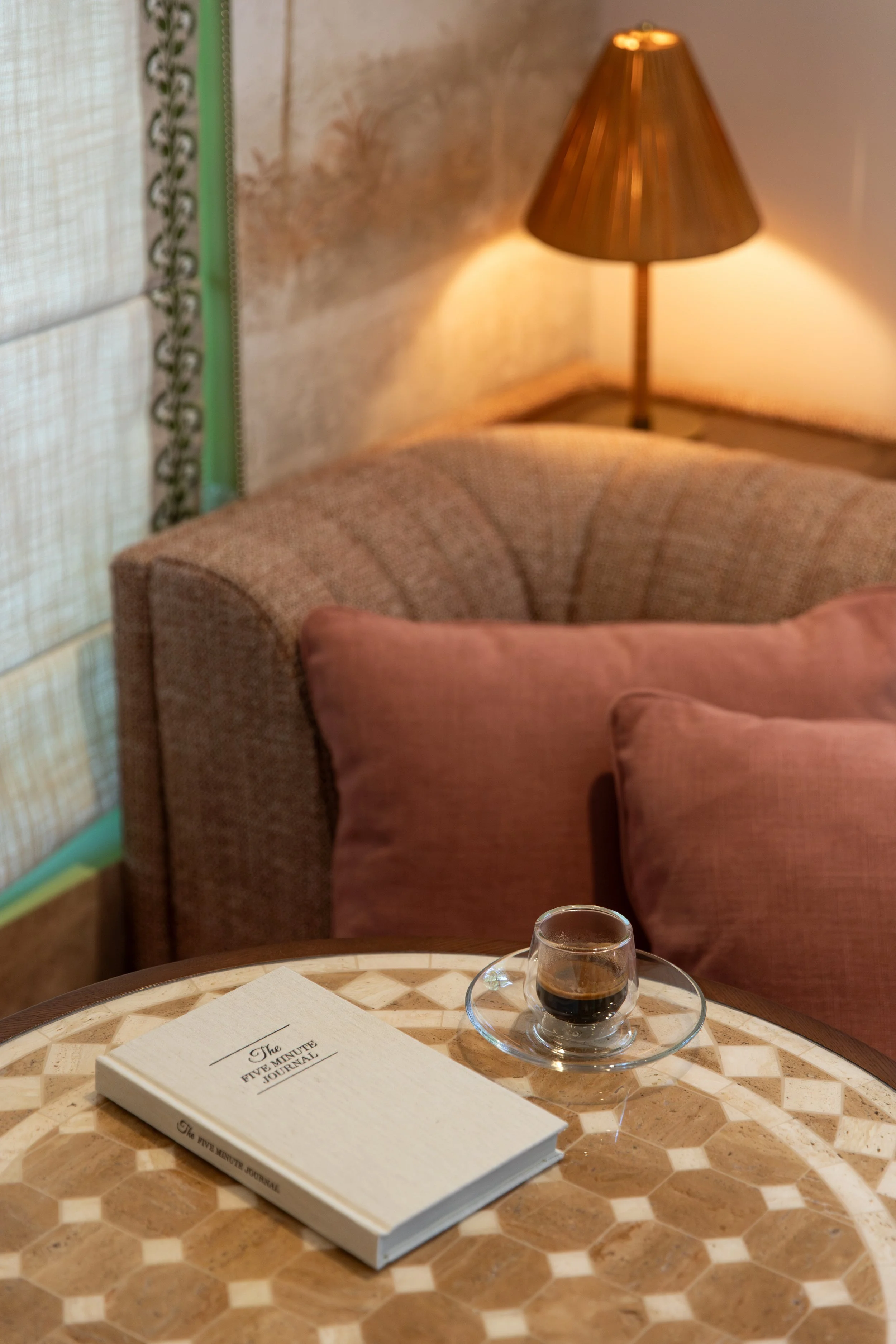 Corner seating area in Olazul with a Five Minute Journal and morning espresso