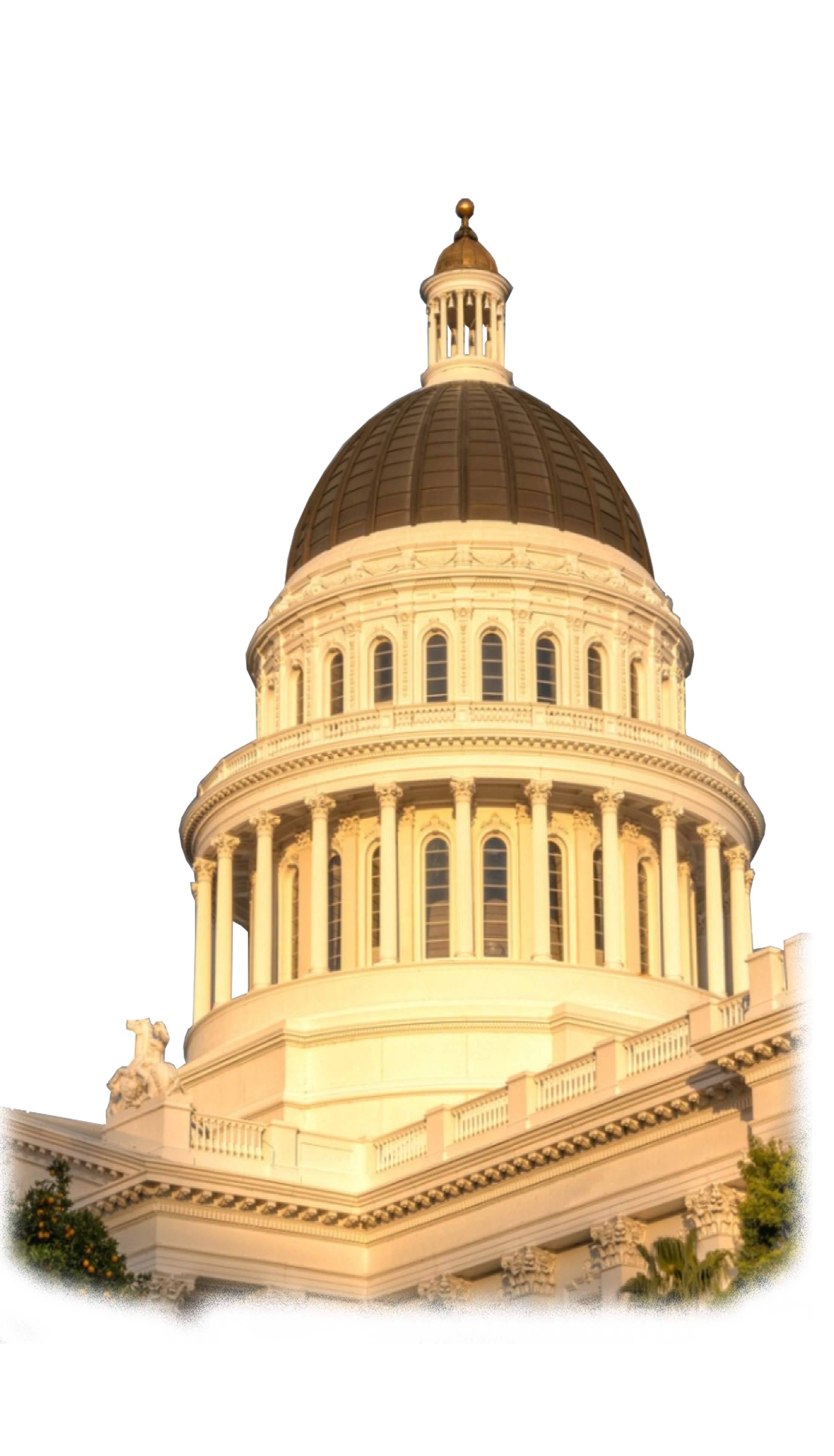 The California State Capitol building in Sacramento, with a large copper dome and classical architectural features, illuminated at sunset.