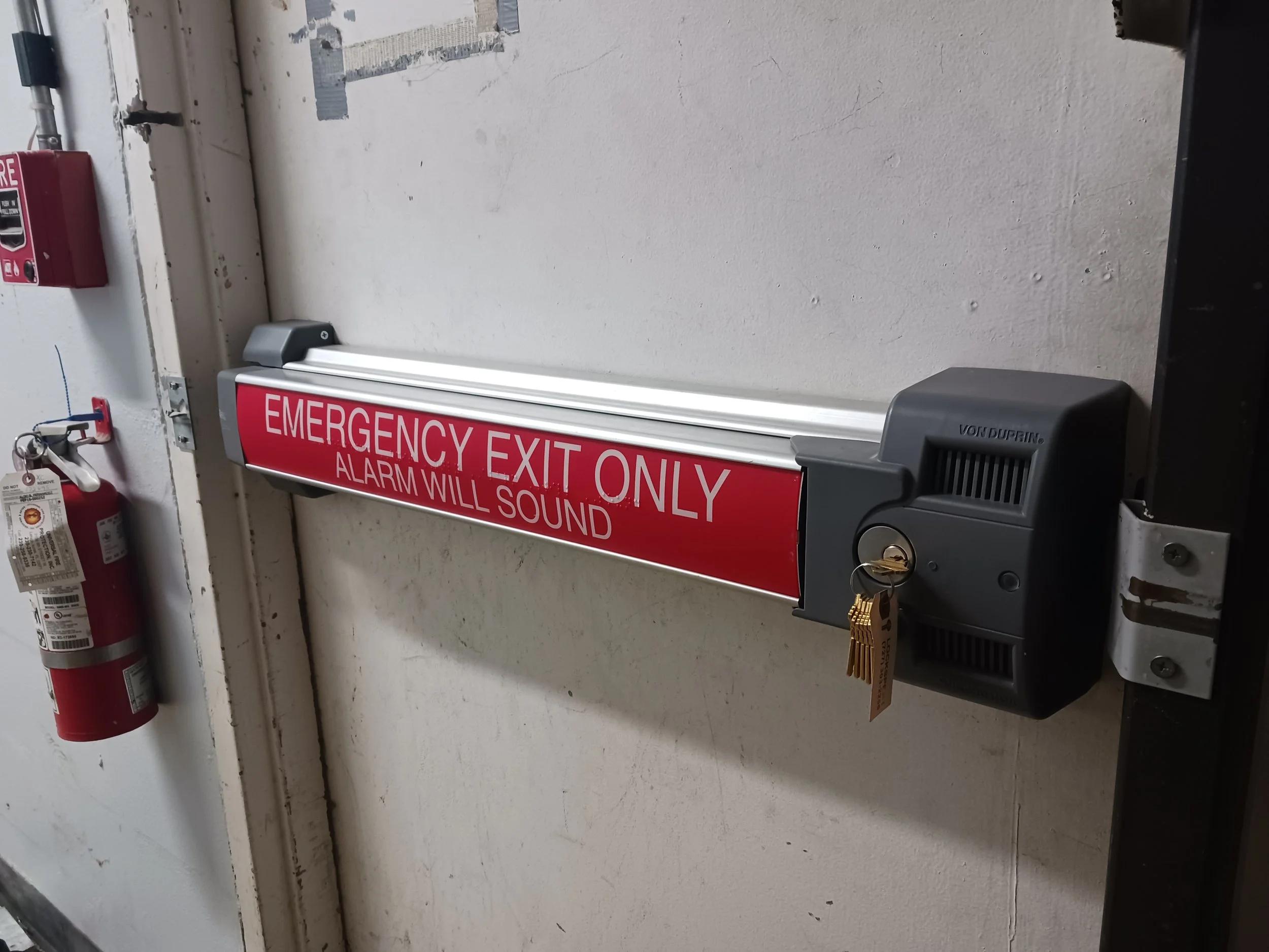 Exit door with an emergency panic exit device installed by Lockspert.