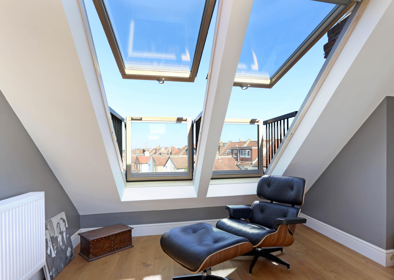 Inspiring London loft conversion by design and build architects, featuring innovative skylight balcony windows opening over London rooftops.