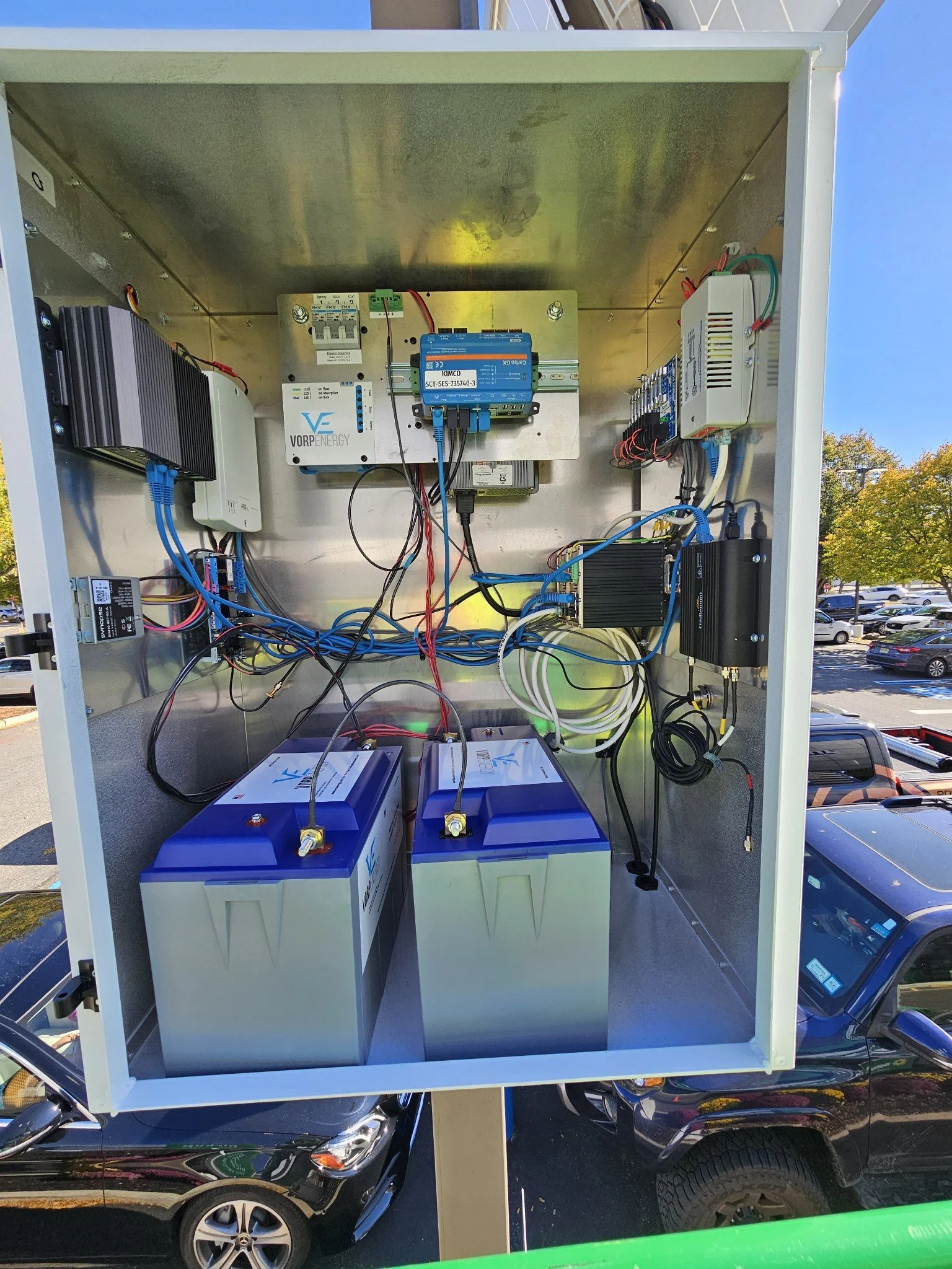 Electrical control box with batteries, wiring, and electronic components.
