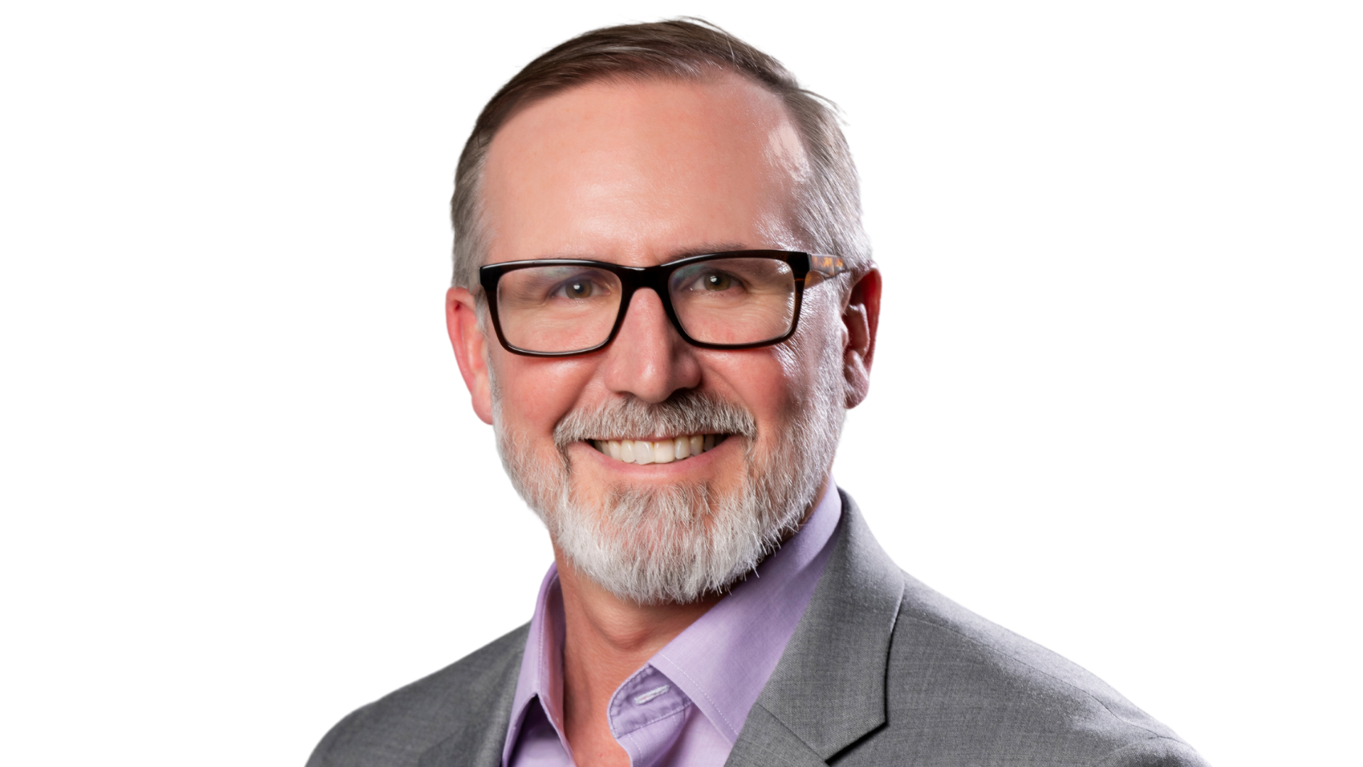 Headshot of a smiling middle-aged man with glasses, gray hair, and a beard, wearing a gray suit and purple shirt, against a white background.