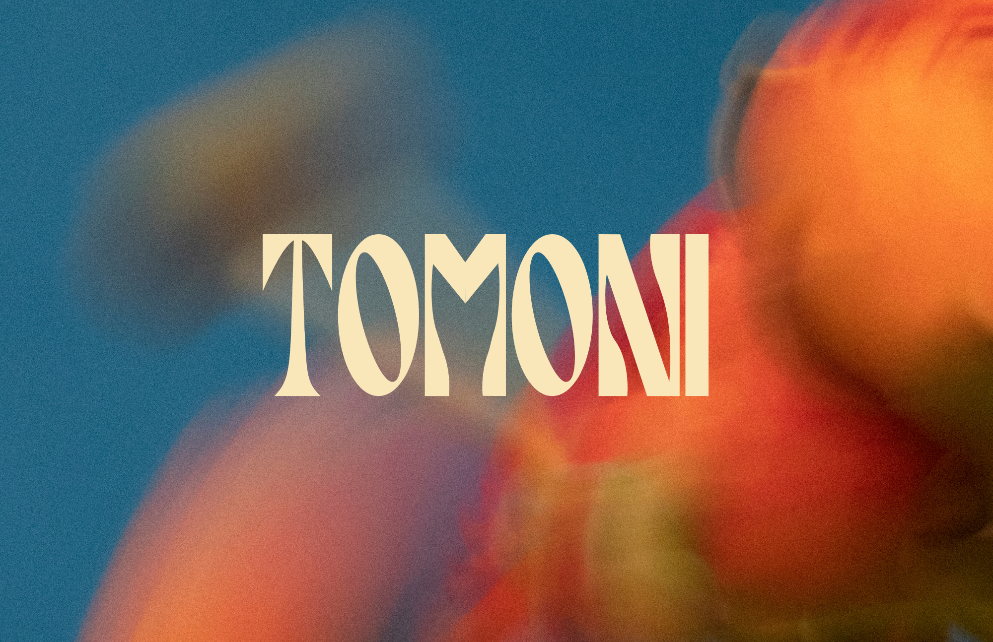 Colorful abstract background with the word 'TOMORROW' written in large, beige letters across the center.