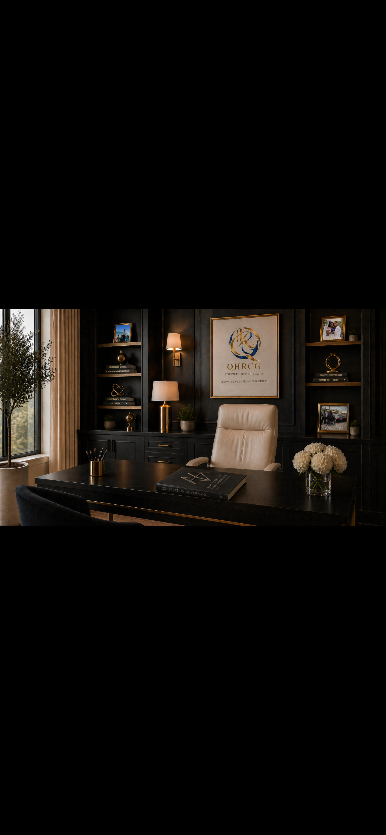 Executive office image for QHRCG featuring framed branding, books, and an Expectation Governance book on the desk