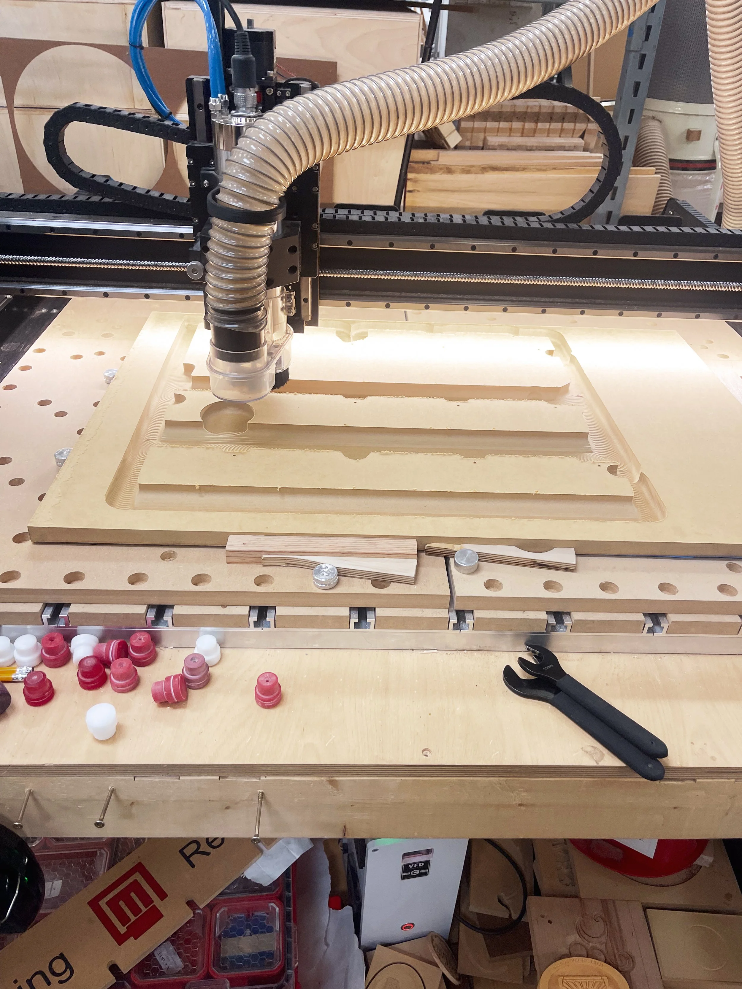 Router in process of creating wooden mold for valve covers