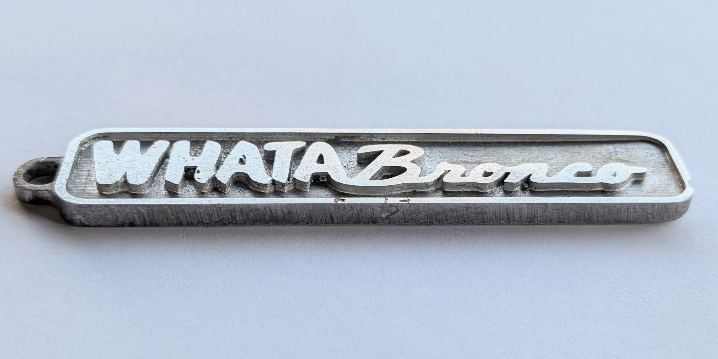 custom keychain for customer who owns a whataburger franchise and drives an orange bronco.
