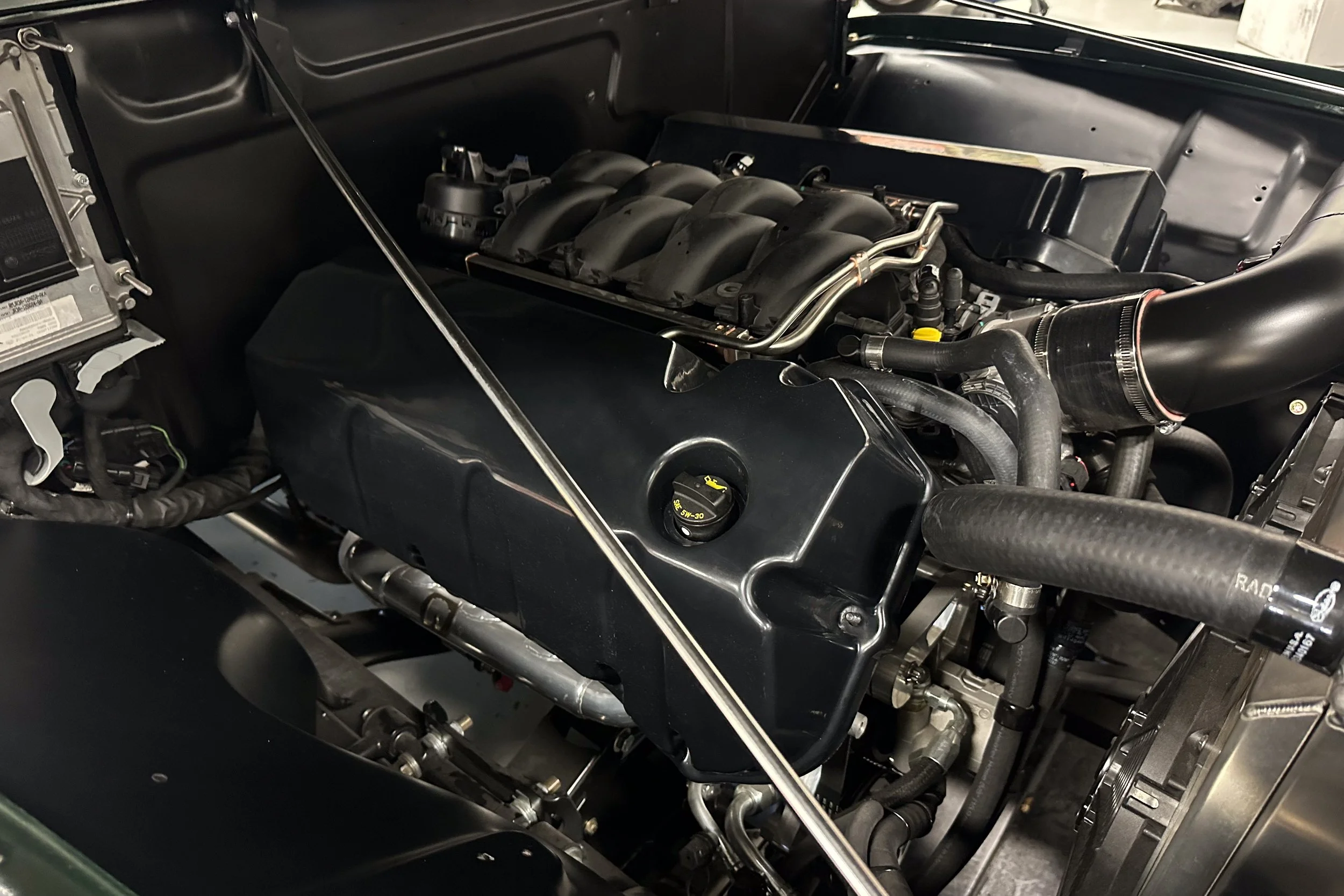 Set of Gen 3 Coyote Engine valve covers installed on 50's era Ford Panel Van