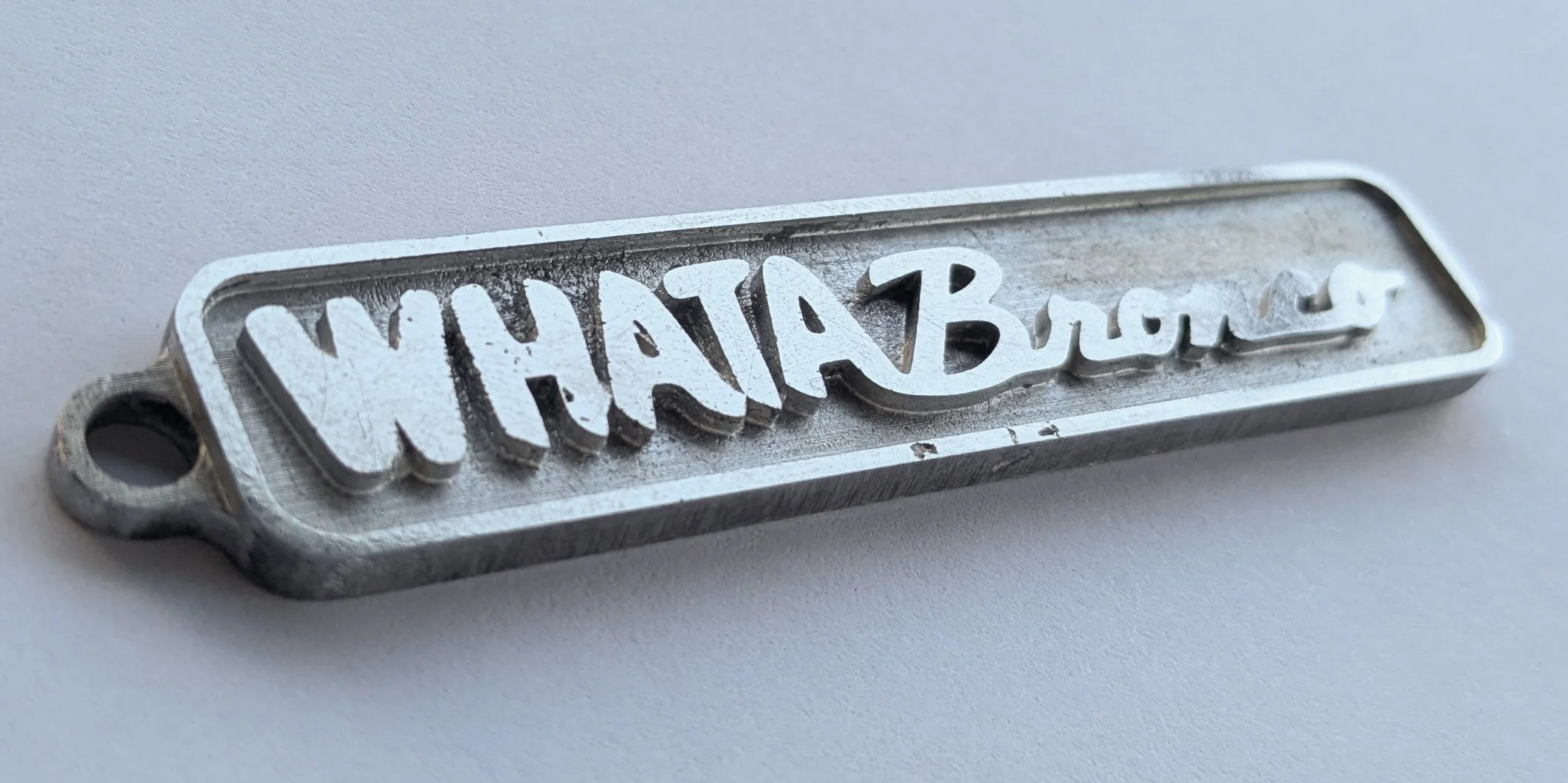 custom keychain for customer who owns a whataburger franchise and drives an orange bronco.