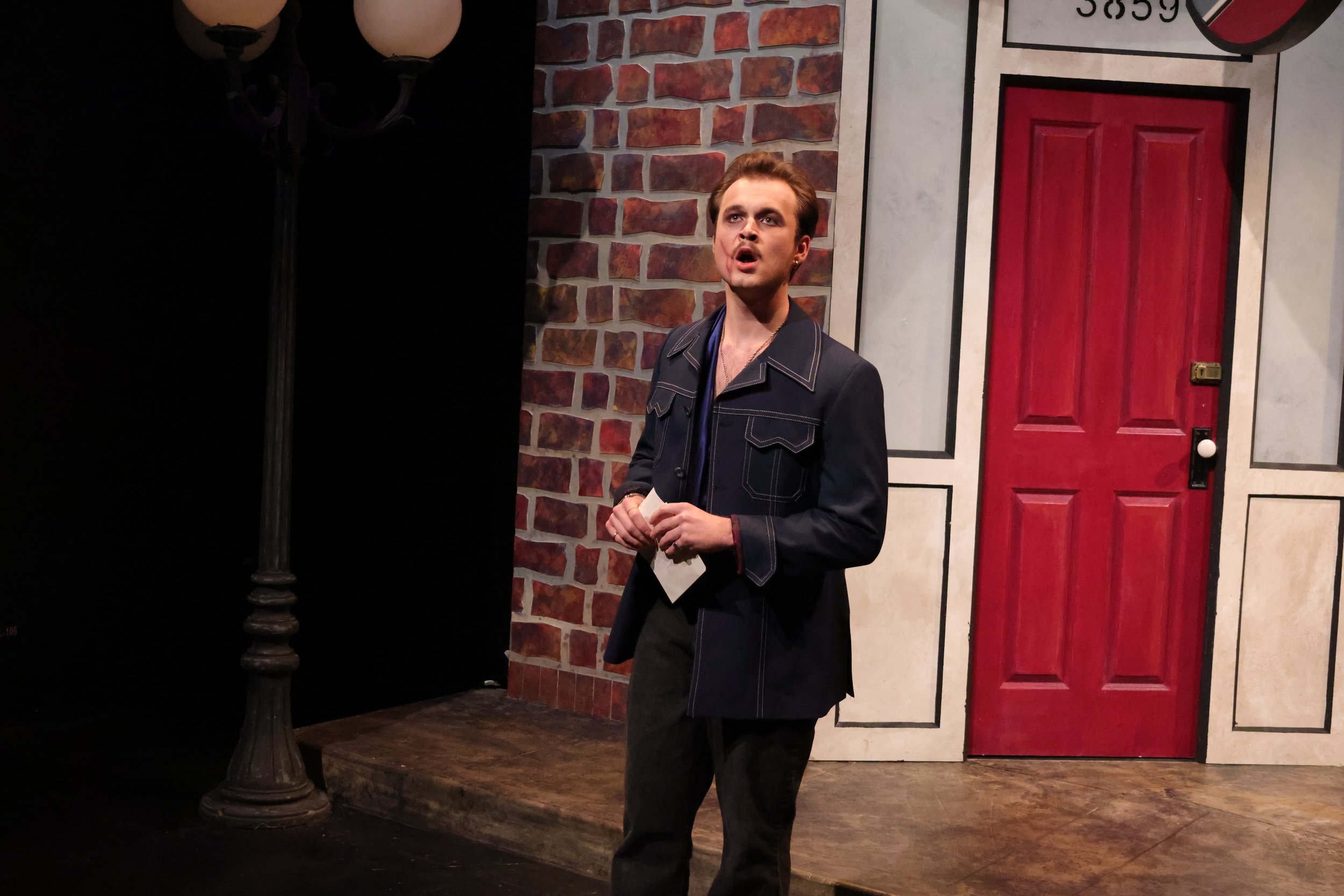 Furio holds a letter from Gilda